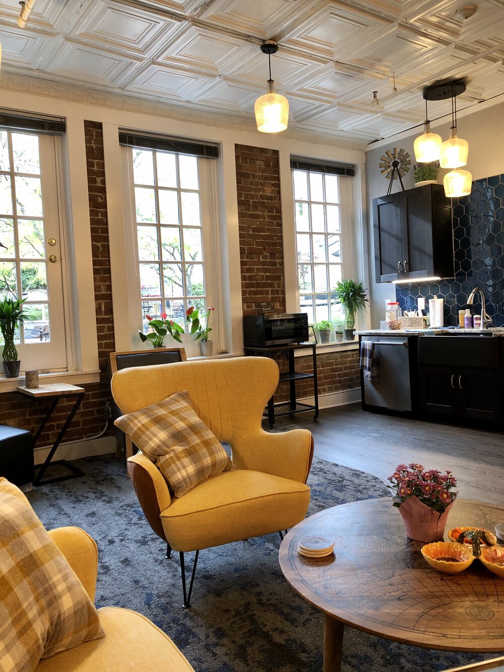 Pantry and kitchen area for co-working space with warm and inviting chairs and tables