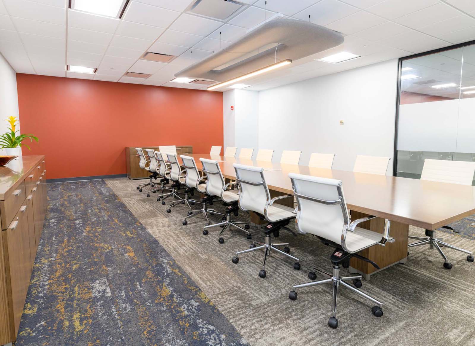 Large conference with long thin table and glass doors