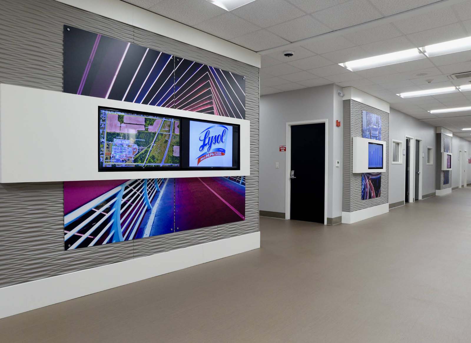 Wall and corridor design with artwork and flat screens