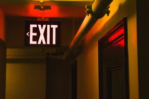 Facility safety plan with Exit sign above hallway