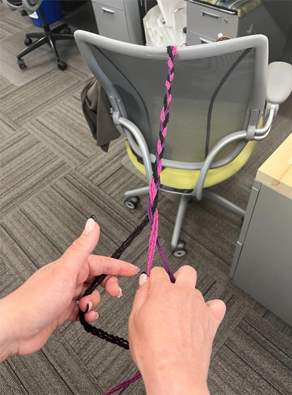 HF Planners staff braiding using office chair