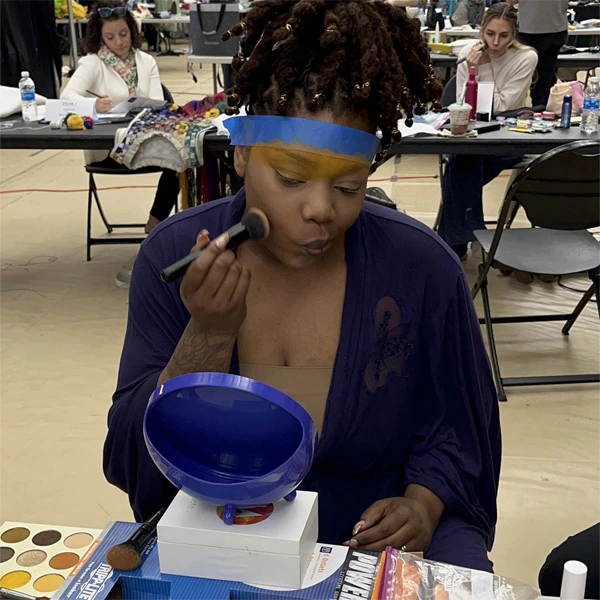 HF Planner staff putting on makeup