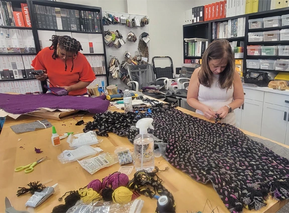 Sandra and Cheryse HF Planners staff sewing fashionable office material
