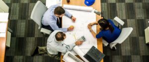 Workers around a table working on a strategic facility plan