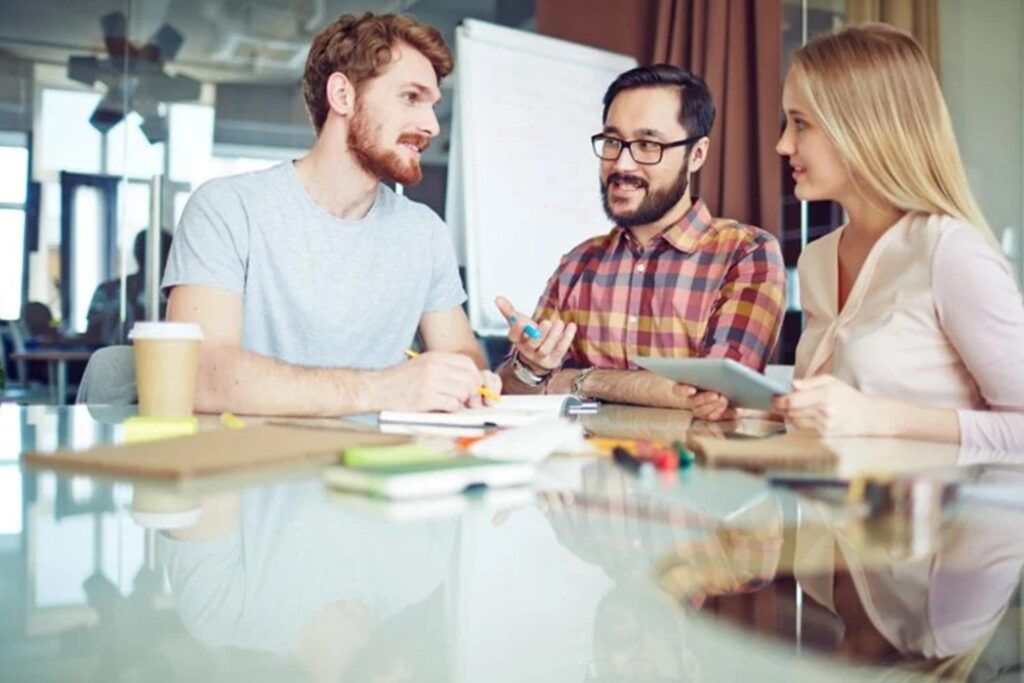 Casual dressed people talking at coffee shop viewing facility management project