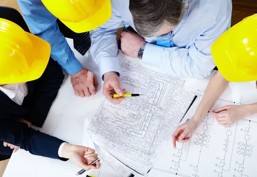 Engineers looking at facility management plan