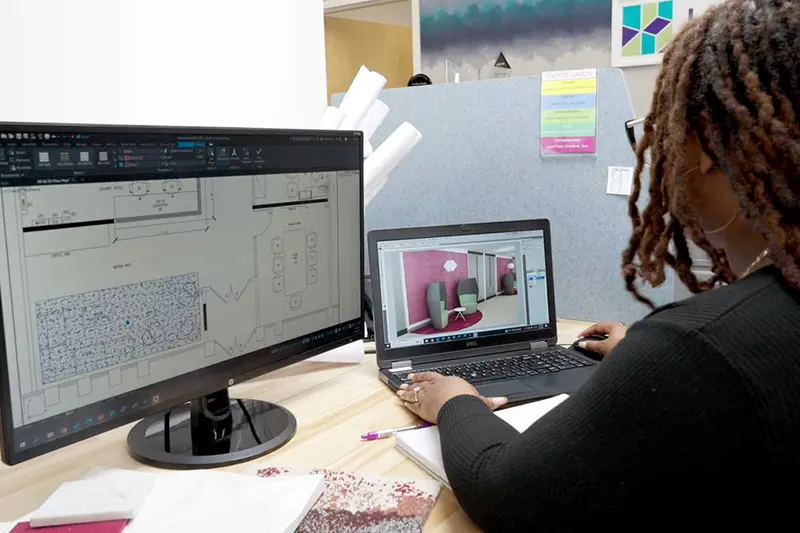 Interior Designer analyzing renderings models in office